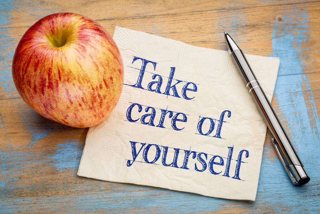 Take care of yourself (rest) advice or reminder - handwriting on a napkin with a fresh apple