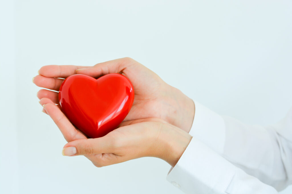 Hands holding a red heart