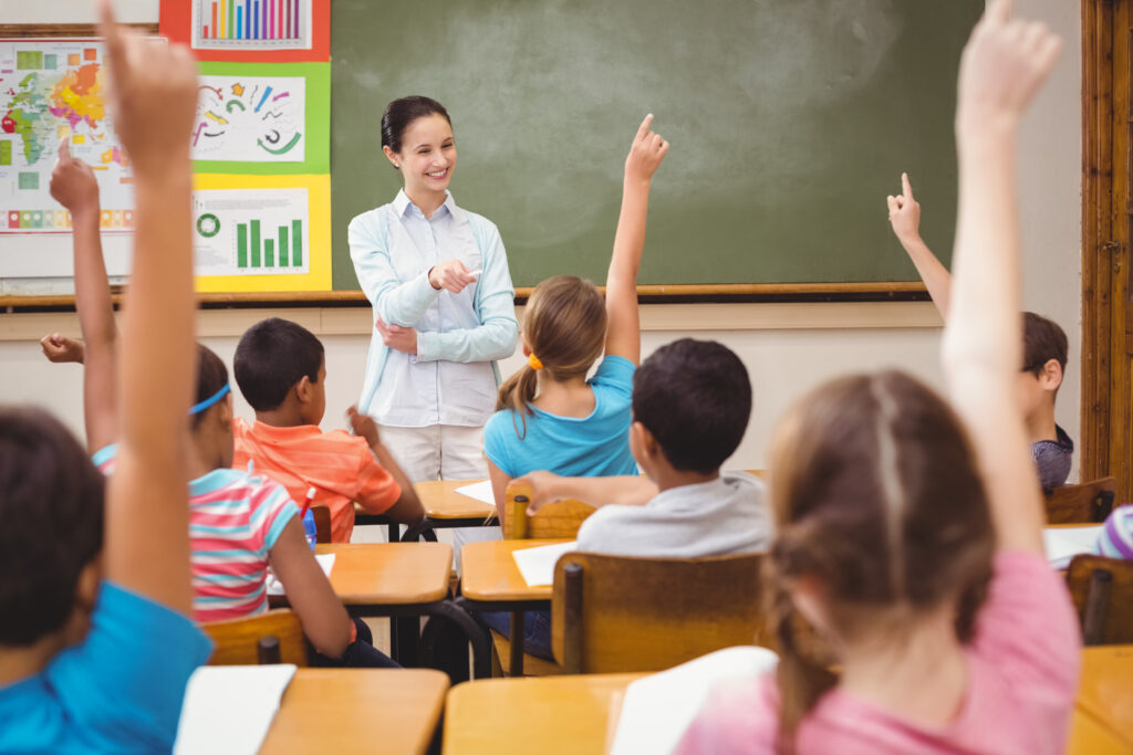 Teacher asking a question to her class at the elementary school