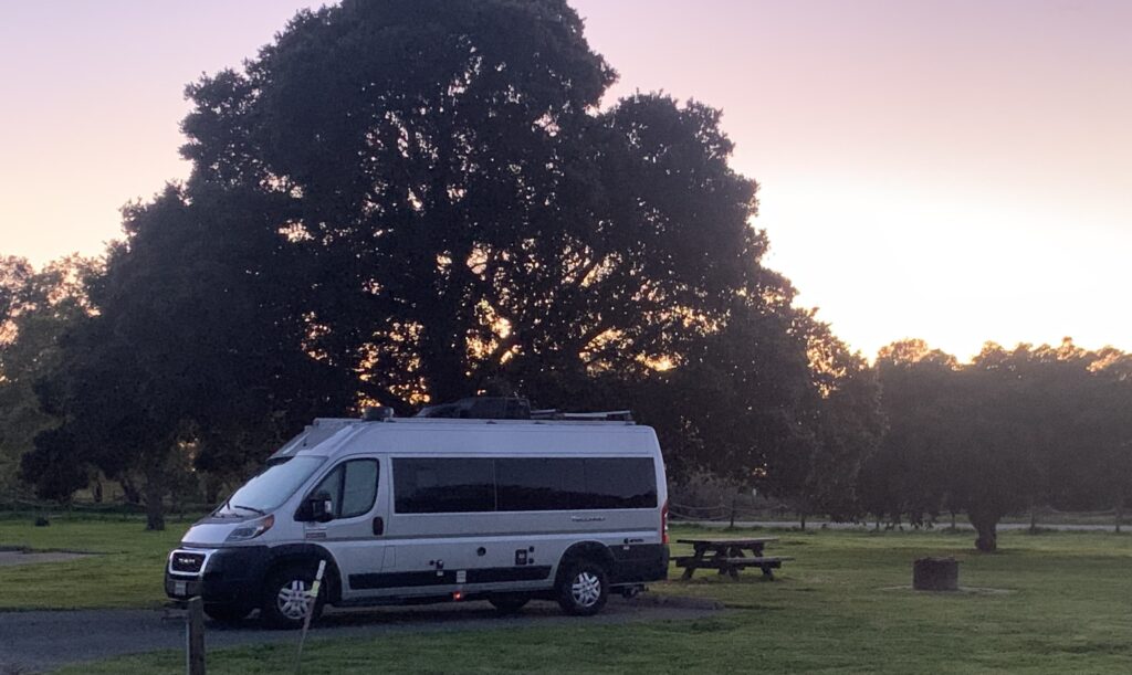travel van at campground during sunset